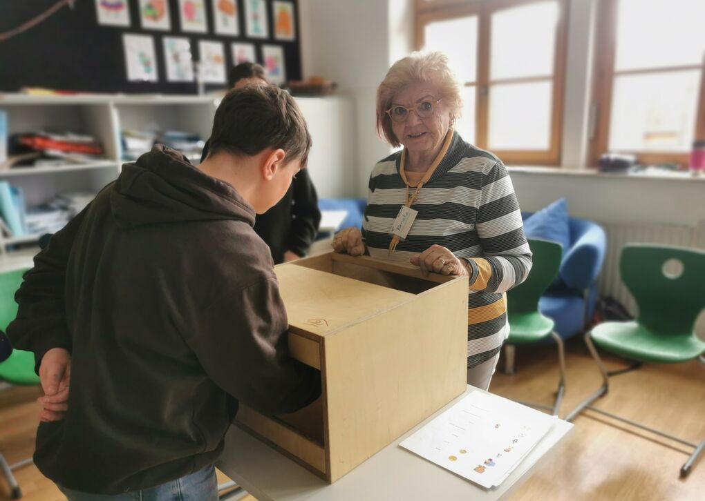 Foto aus Workshop Vergiss mein nicht, zeigt Freiwillige mit Schüler